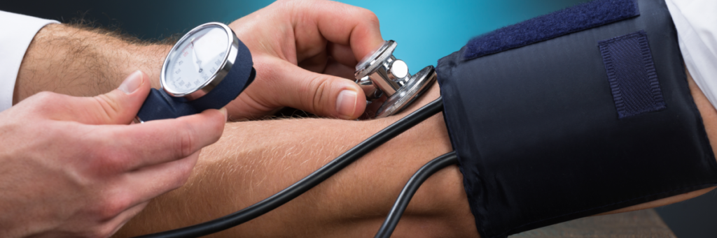 person getting their blood pressure checked person getting their blood pressure checked