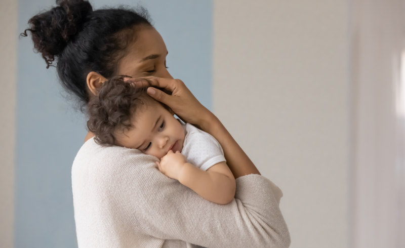 Woman holding infant Woman holding infant